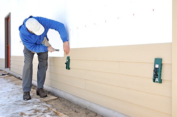 Cracked and loose siding panels on a home exterior